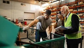 two-workers-showing-quality-control-inspector-industrial-machine-they-are-using-distribution-warehouse